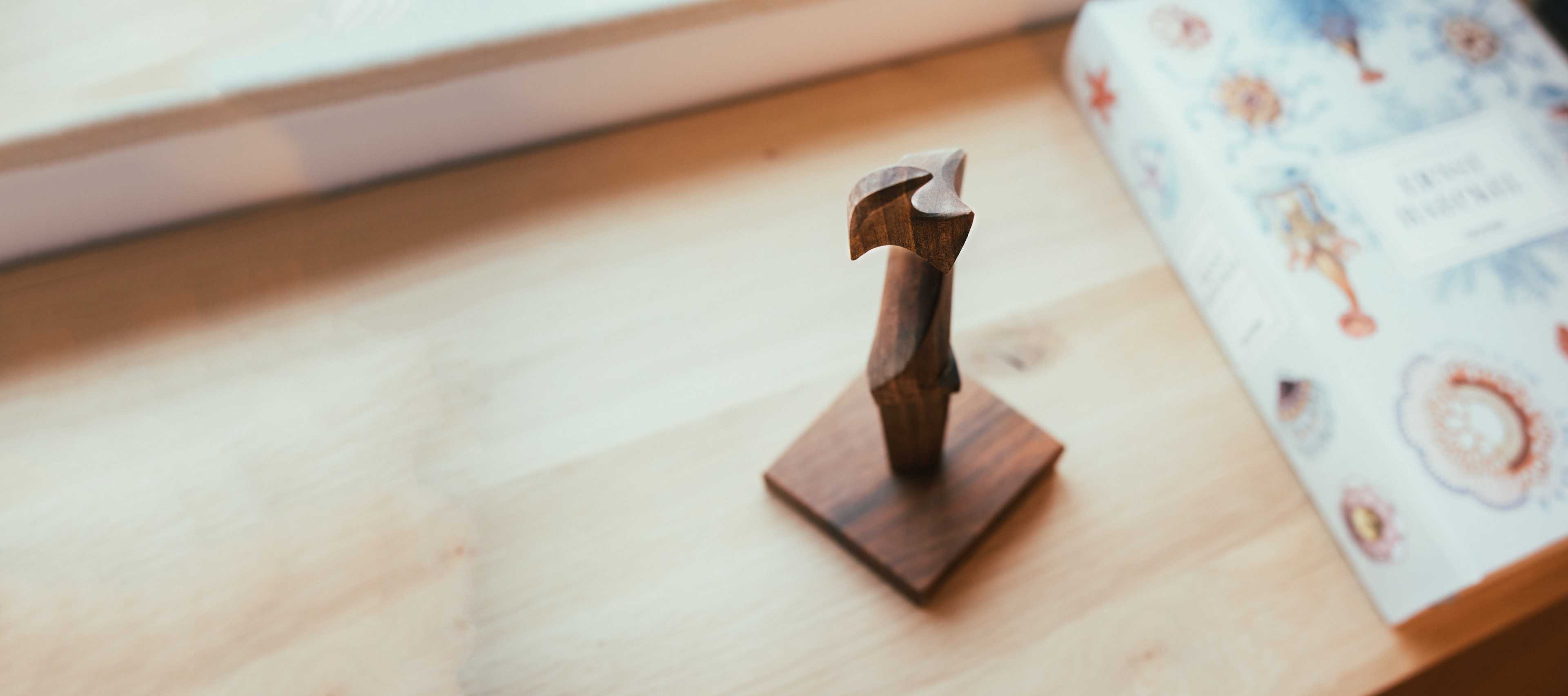 Een houten figuur op een bureau